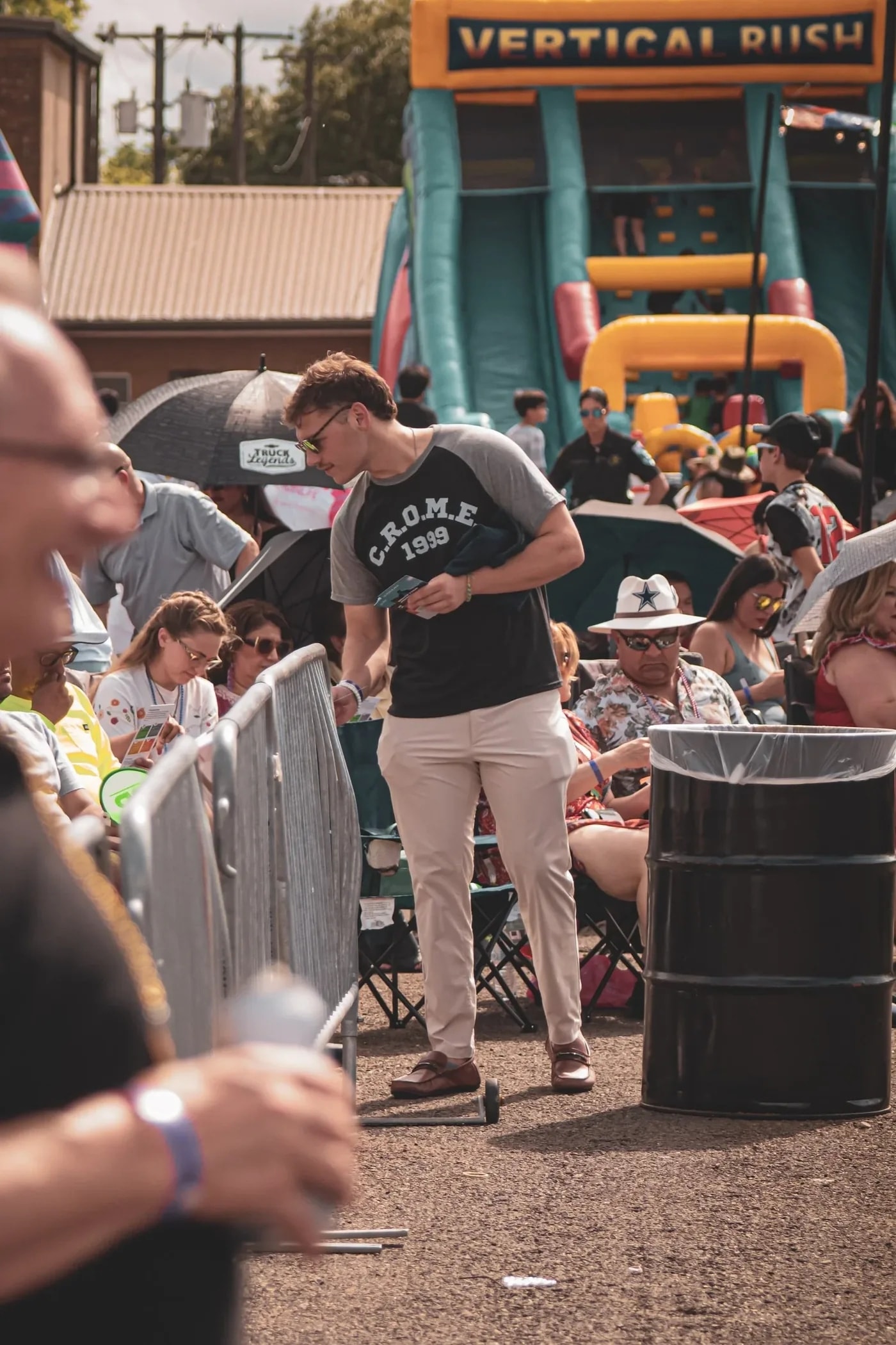 A CROME volunteer speaking with people at a community event
